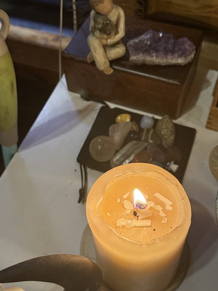 An image of a candle on a prayer table